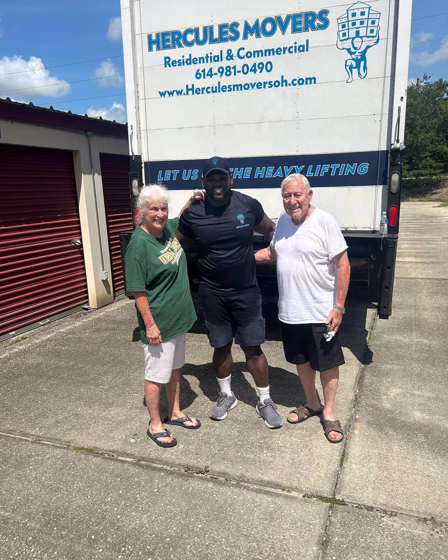 Three people standing in front of moving truck
