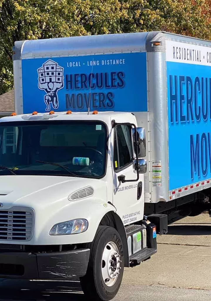 Hercules Movers truck parked on residential street.