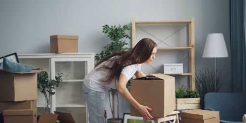 Woman packing boxes and following a moving timeline to move to a new house