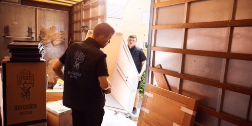 Movers loading furniture into a truck