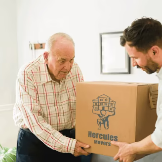 Two men lifting moving box together indoors.